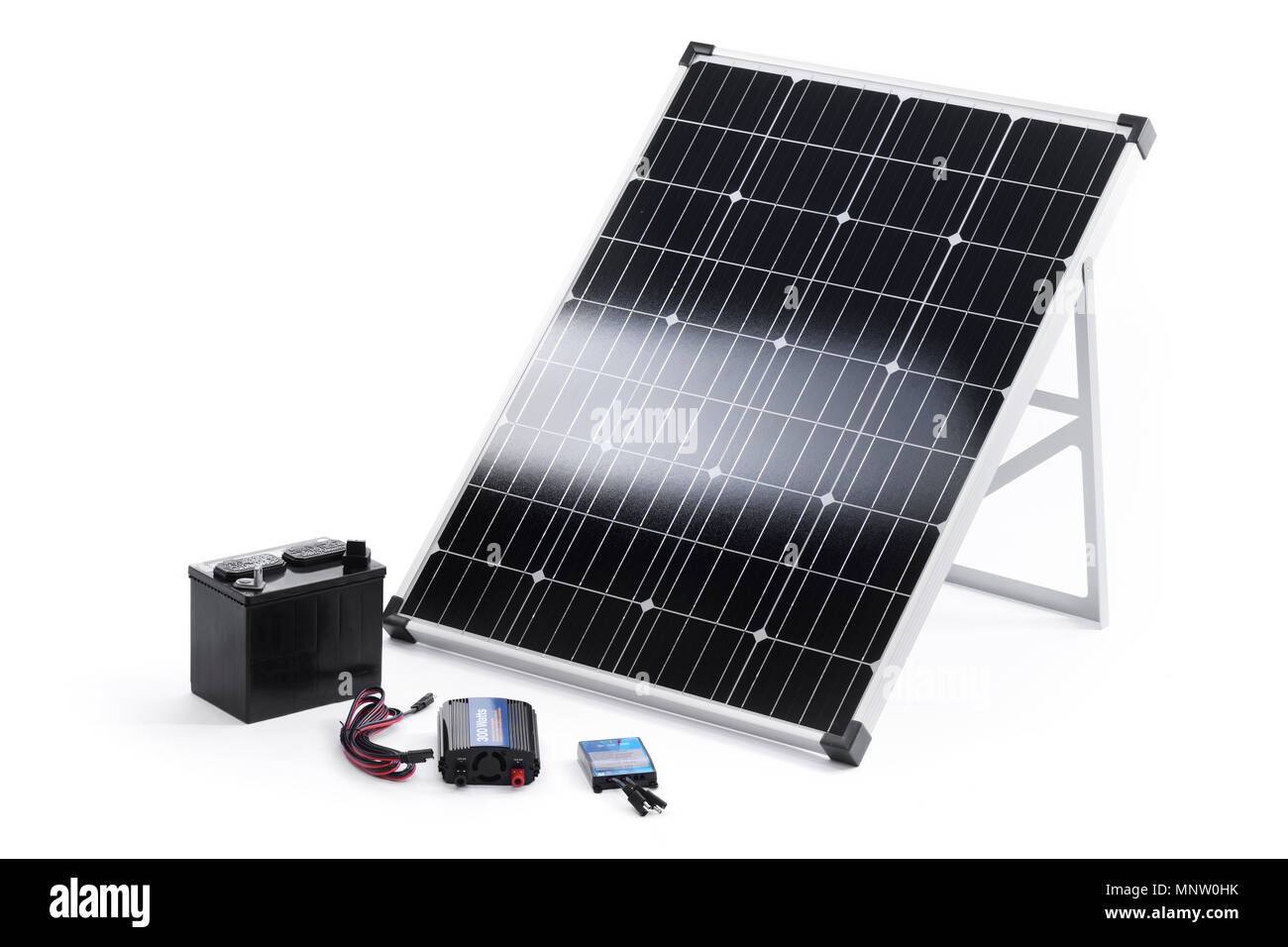 Solar power kit with a portable 100 Watt crystalline solar panel, inverter, charge controller and a battery isolated on white background Stock Photo