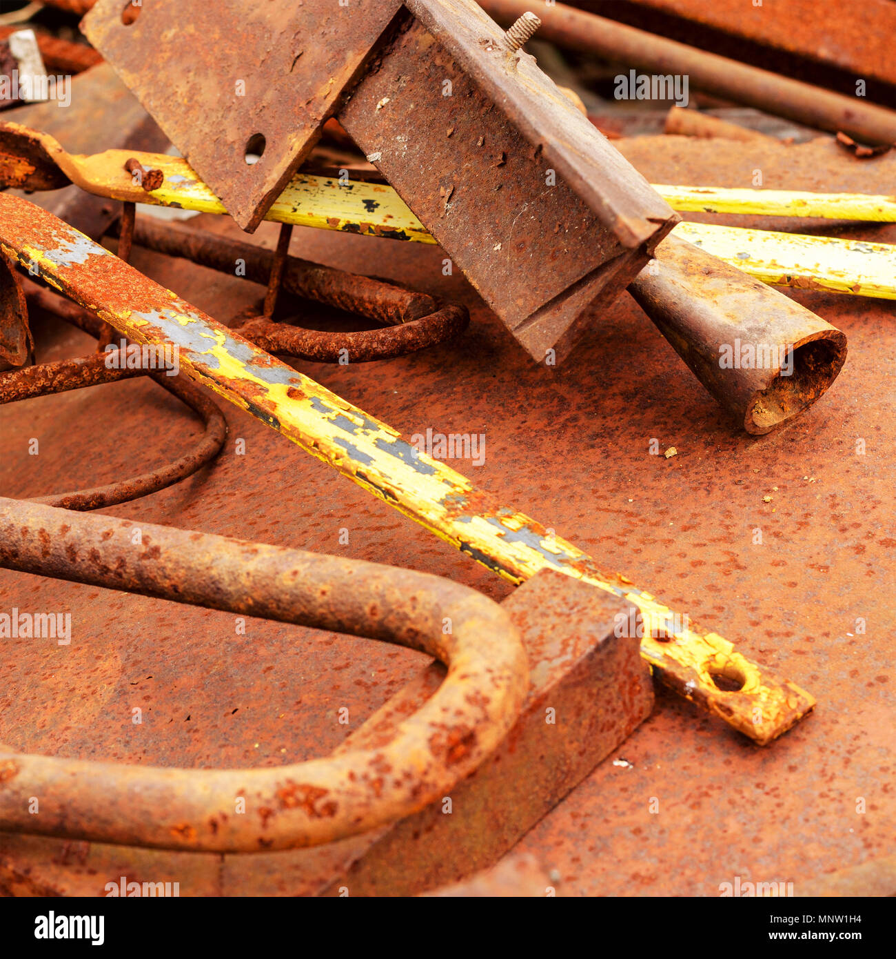 Pile of different old, rusted scrap metal.Square. Toned. Close-up. Stock Photo
