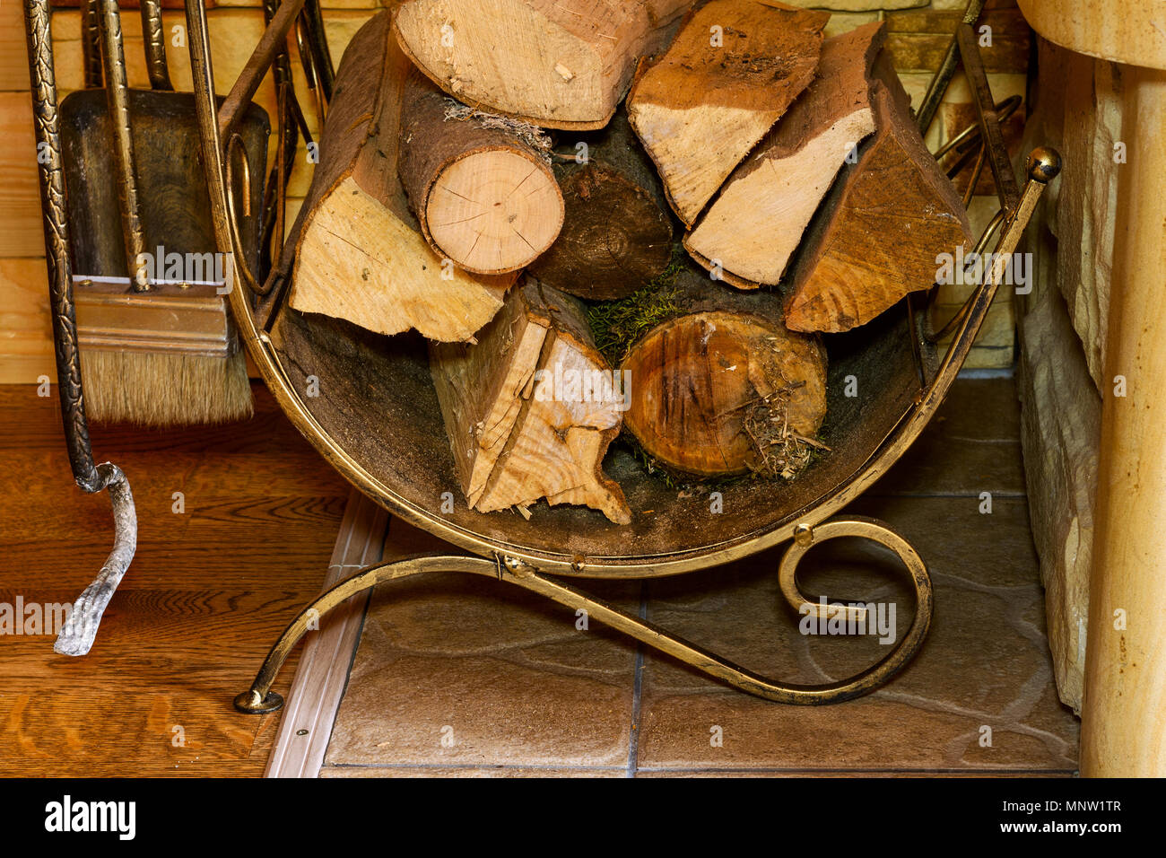 Stack Of Dry Firewood And Fireplace Accessories Stand Near House