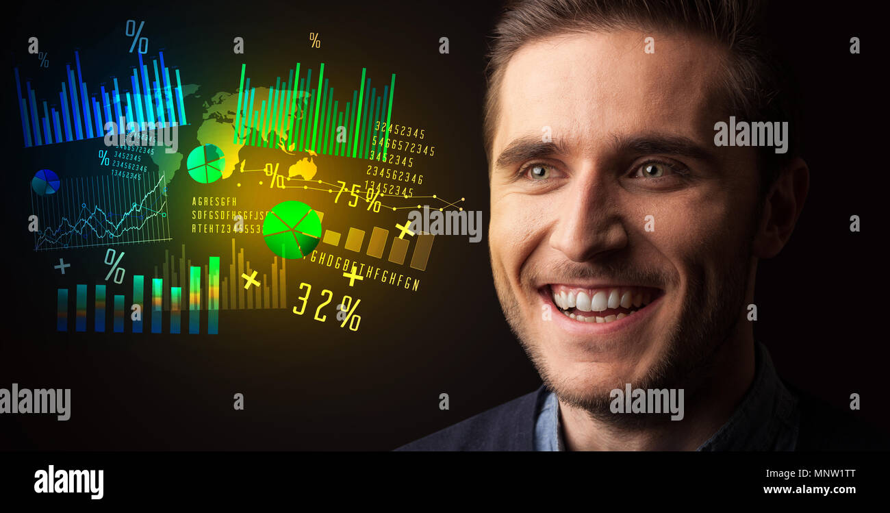 Portrait of a young businessman with colorful charts and graphs next to ...