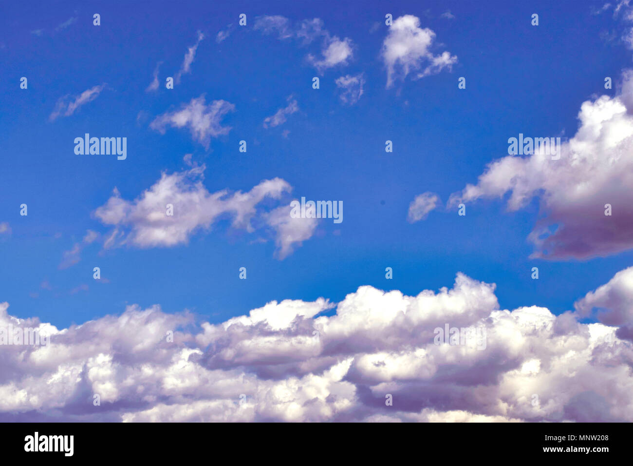 White fluffy clouds in the vast blue sky. Abstract nature background ...