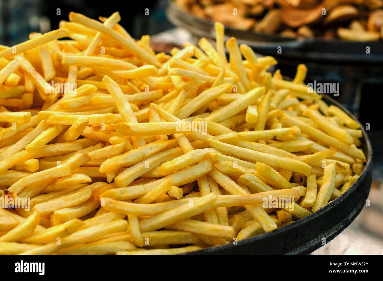 Production of french fries. Large pan of fresh fried sweet potato. Close-up. Stock Photo