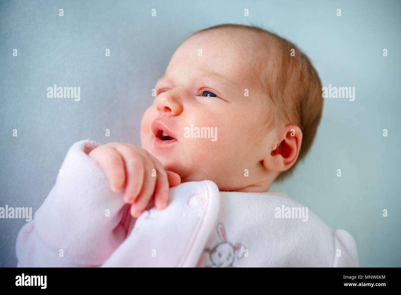 Emotional baby lying in cradle. Insomnia and sleep disorders concept Stock Photo