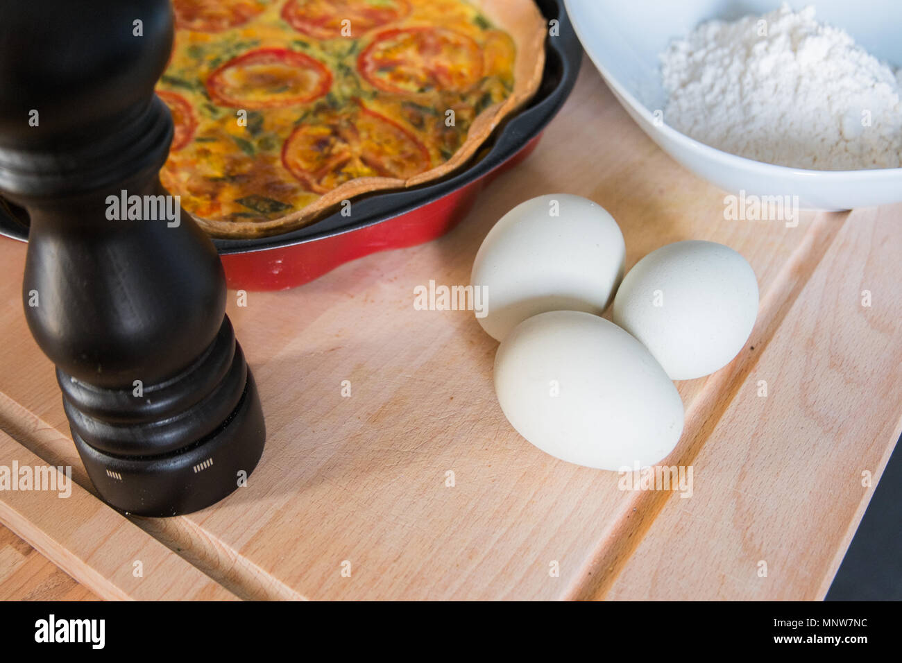 fresh quiche with green eggs, tomatos and spring onions Stock Photo