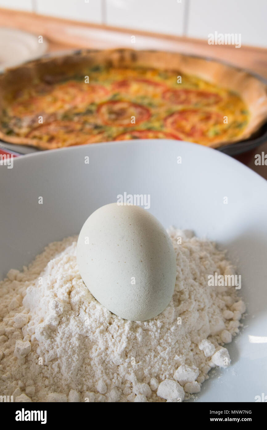 fresh quiche with green eggs, tomatos and spring onions Stock Photo