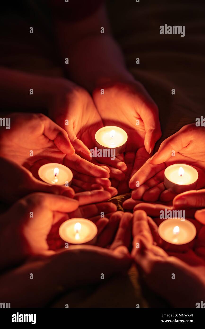 prayer with candles in hands Stock Photo Alamy