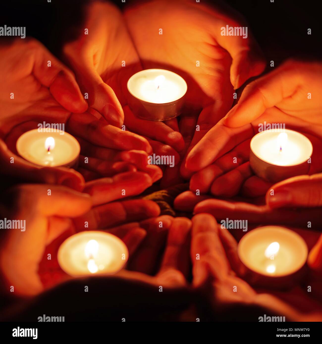 prayer with candles in hands Stock Photo Alamy
