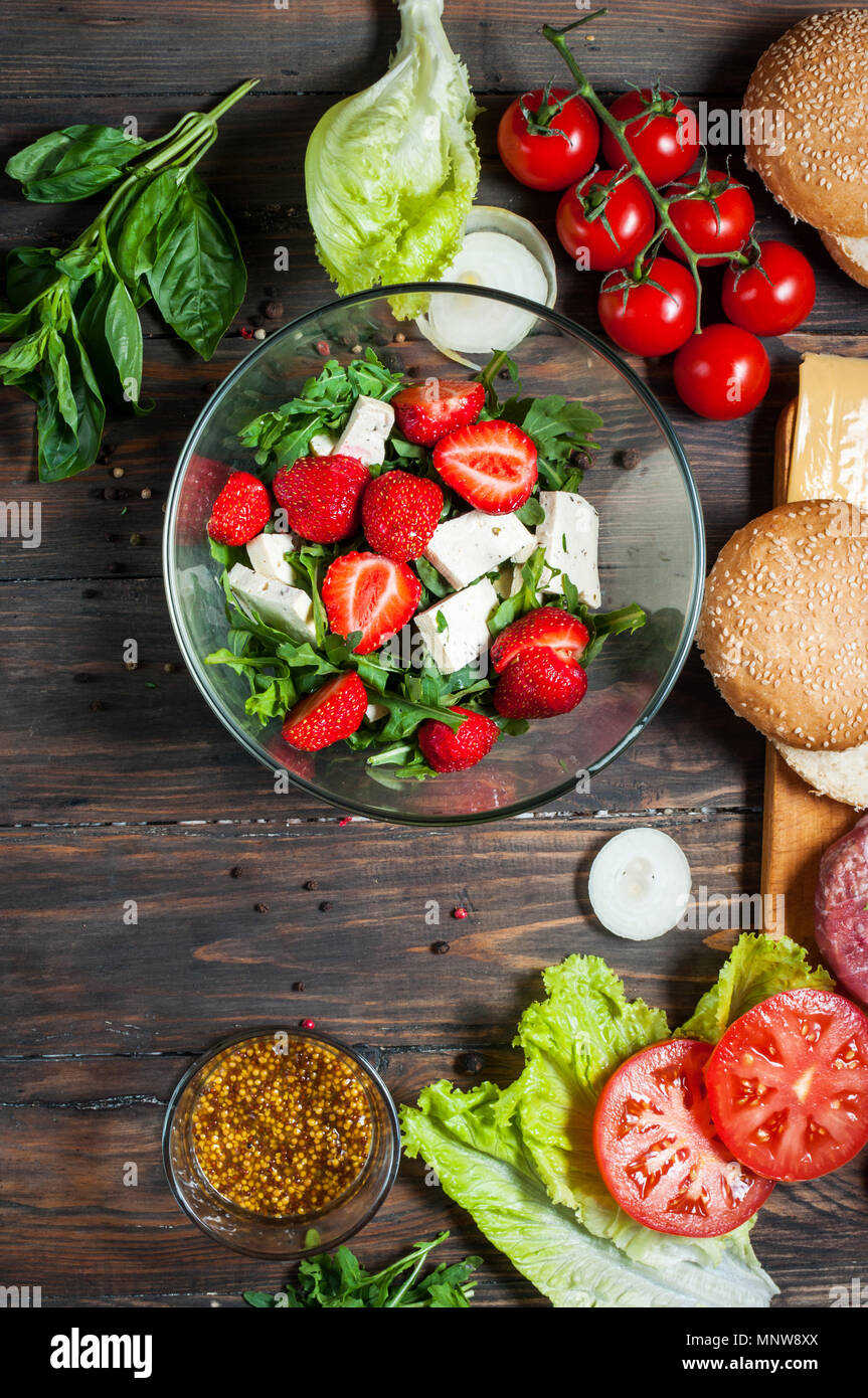 Ingredients for making homemade burger and salad with strawberries, tofu. Stock Photo