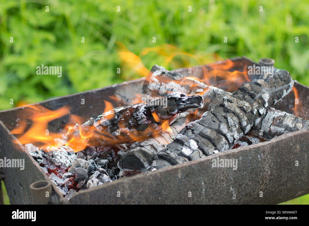 Smoky and blazing firewood in a brazier almost turned into coals Stock  Photo - Alamy