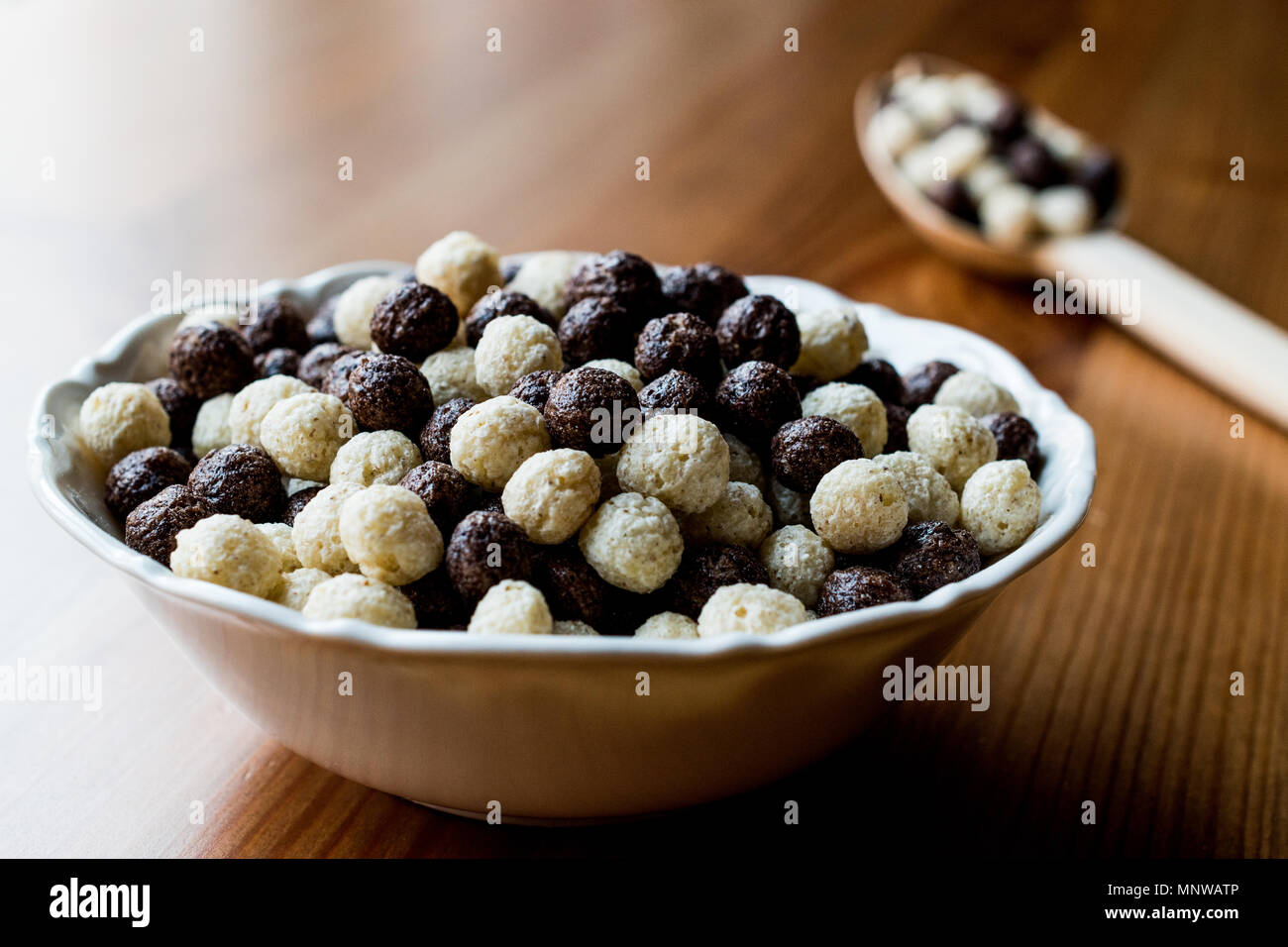Chocolate Cereal balls in bowl with wooden spoon. Breakfast Concept
