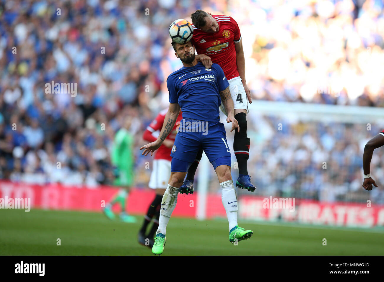 Phil Jones of Manchester United jumps for a header with Olivier Giroud of Chelsea. The Emirates FA Cup final 2018,  Chelsea v Manchester United at Wembley Stadium in London on  Saturday 19th May 2018.  this image may only be used for Editorial purposes. Editorial use only, license required for commercial use. No use in betting, games or a single club/league/player publications. pic by Andrew Orchard/Andrew Orchard sports photography/Alamy Live news Stock Photo