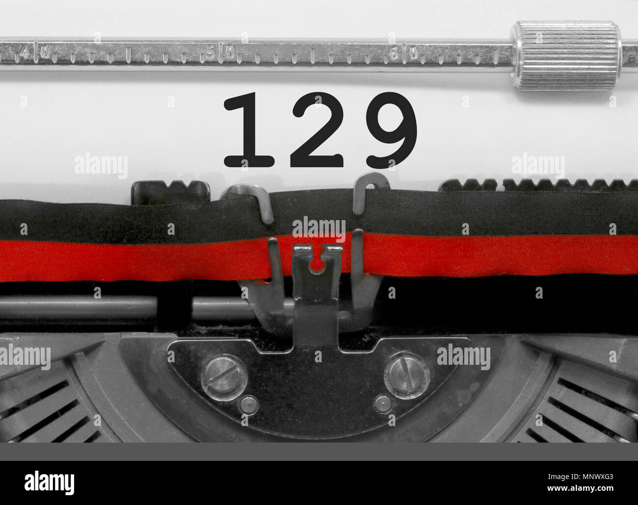 129 Number text written by an old typewriter on white sheet Stock Photo