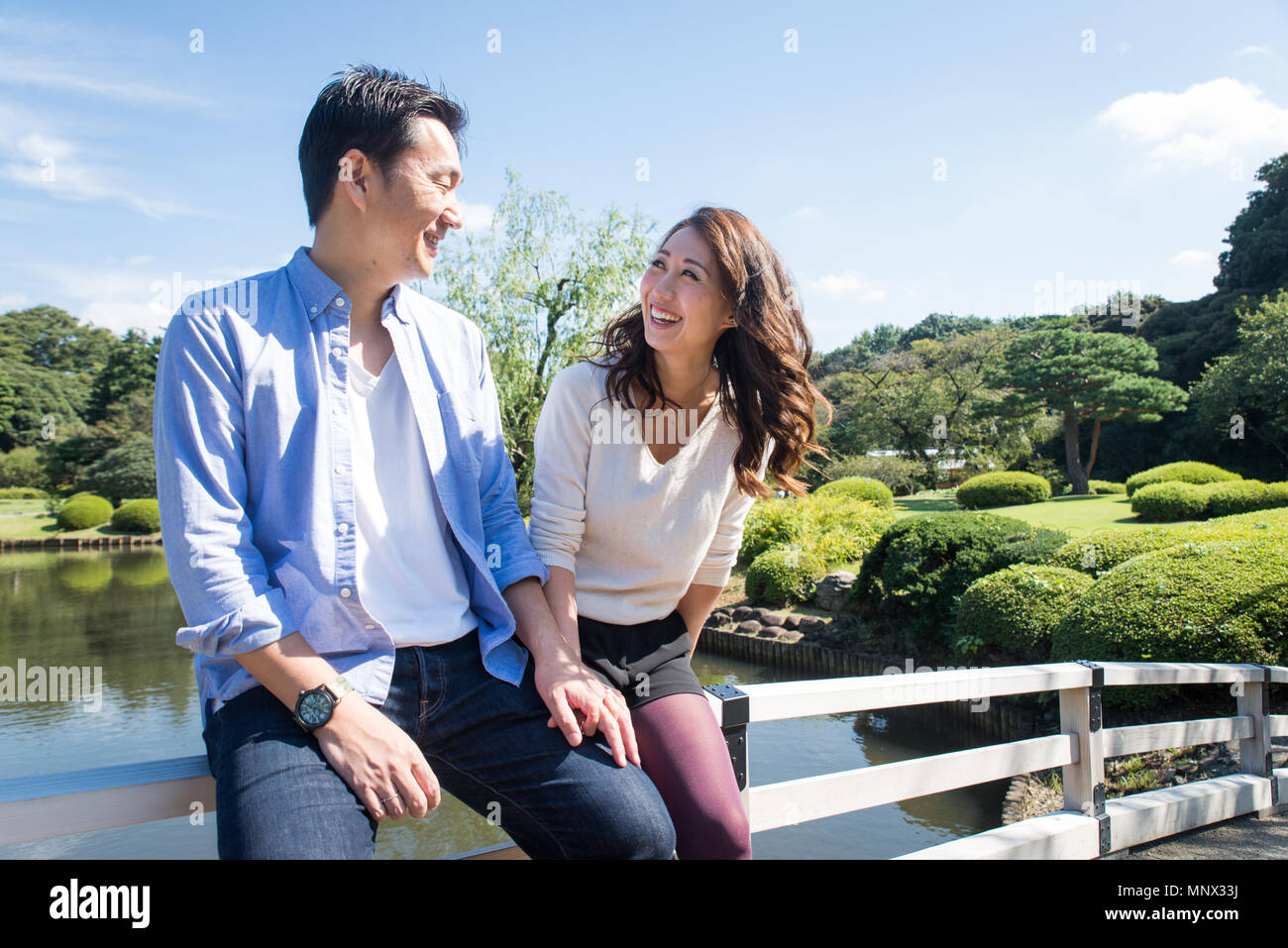 Beautiful asian couple dating in a park - Japanese man and woman having fun  outdoors Stock Photo - Alamy