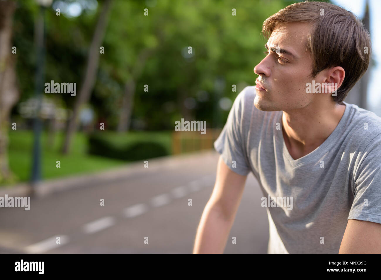 Young handsome man relaxing at the park Stock Photo