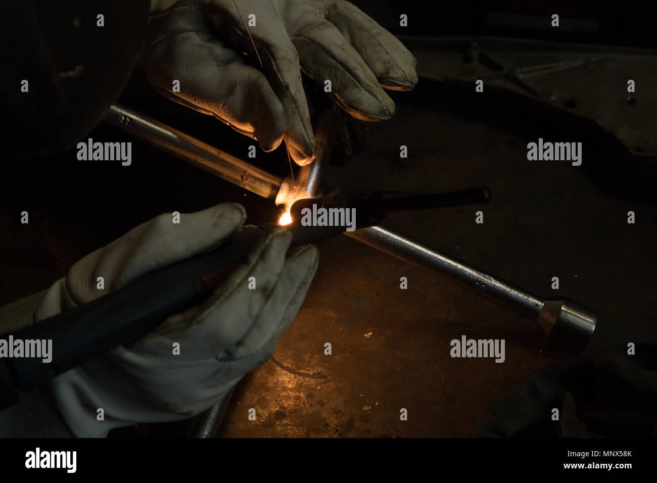 hands of the welder solder and connect the parts Stock Photo Alamy