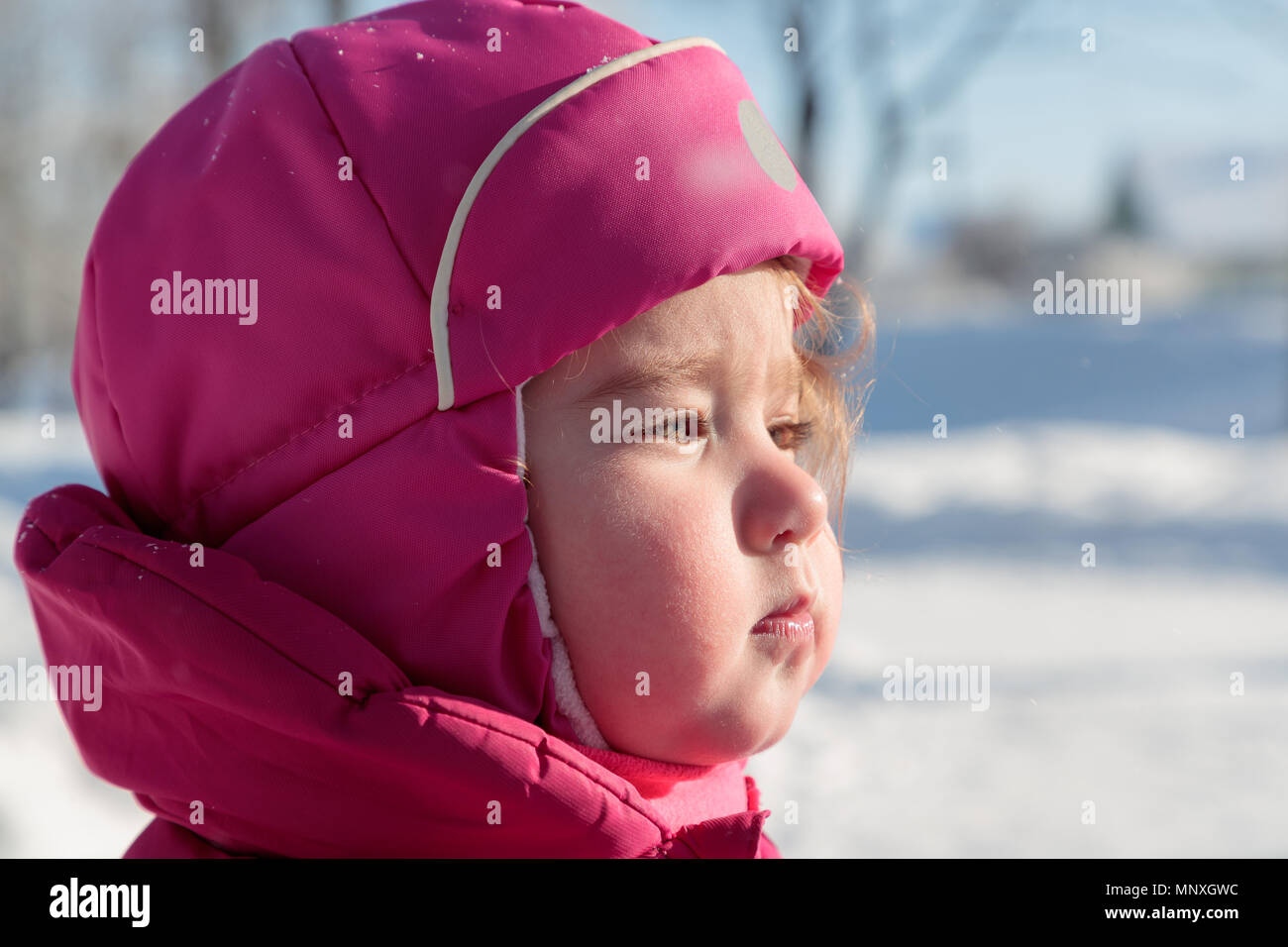 cute face of a little girl in winter clothes on the street Stock Photo ...