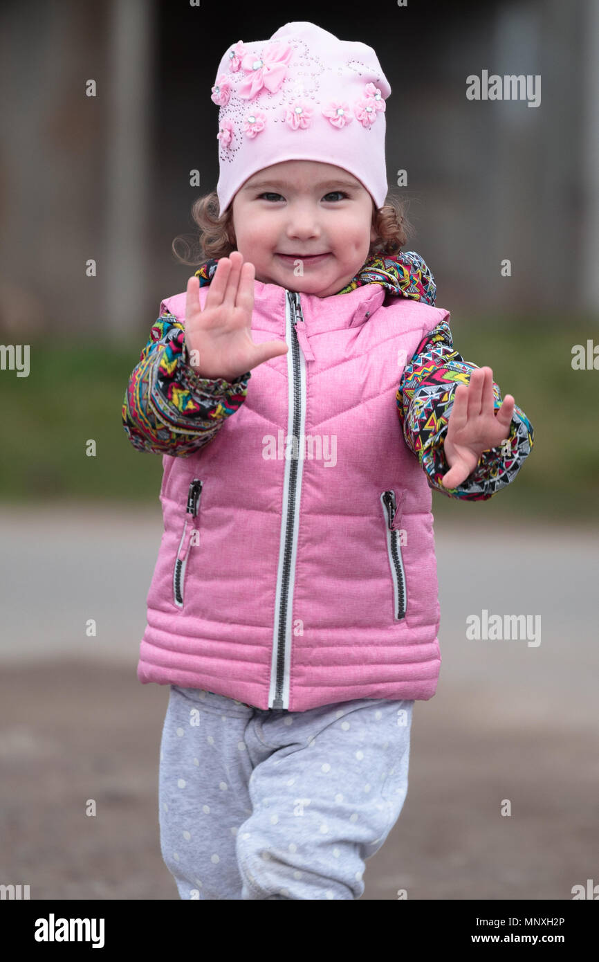 cute and little positive child on the street Stock Photo