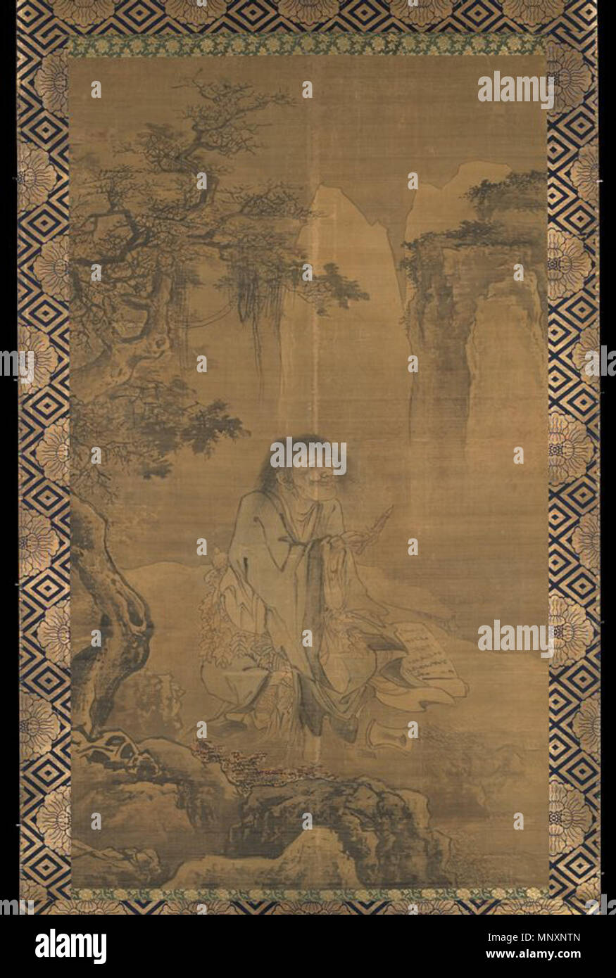 The Immortal Hanshan . Here, an unkempt Hanshan is shown sitting cross-legged, holding a brush beneath a tree tangled with vines, with an inkstone and scroll on the ground beside him. circa 1500.   1175 The Immortal Hanshan Stock Photo