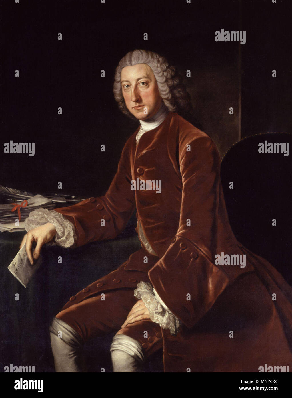 William Pitt, later First Earl of Chatham (1708–1778) .  English: Portrait of the British statesman William Pitt, 1st Earl of Chatham (1708–1778), at three-quarter length, grey wig falling behind shoulders; rich brown velvet suit, white cravat, shirt and wrist ruffles; on the table an inkstand, pen and papers, a letter in his right hand; brown interior background; lit from left. . circa 1754.   1267 William Pitt, 1st Earl of Chatham by William Hoare Stock Photo