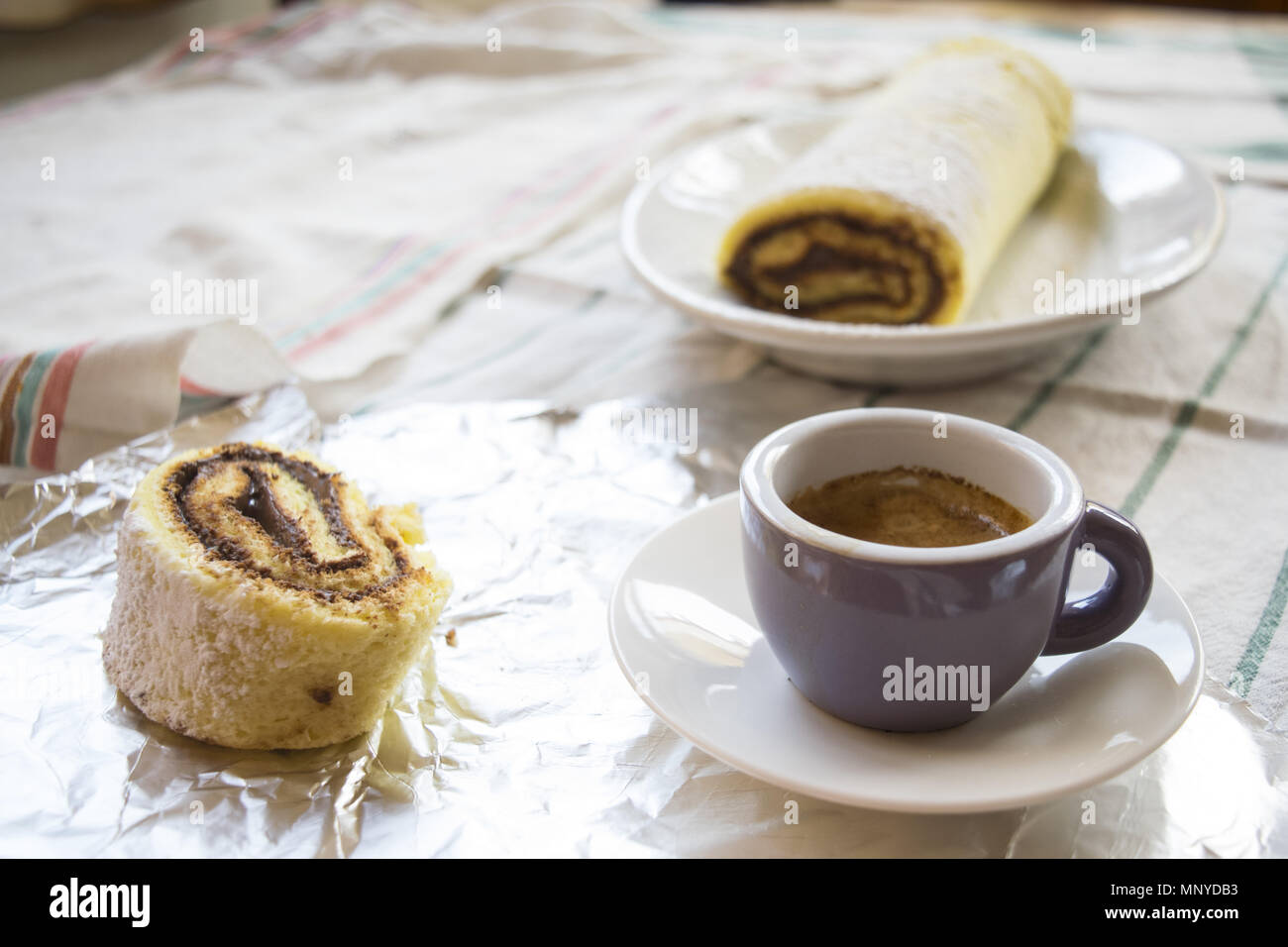 breakfast with Swiss roll with chocolate filling and espresso Stock Photo