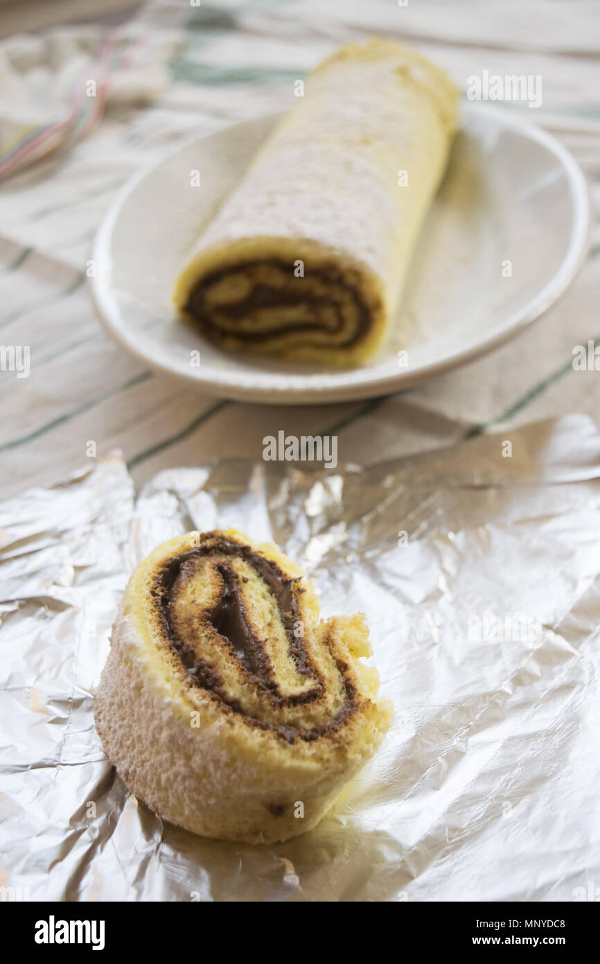 Swiss roll with melted chocolate filling Stock Photo