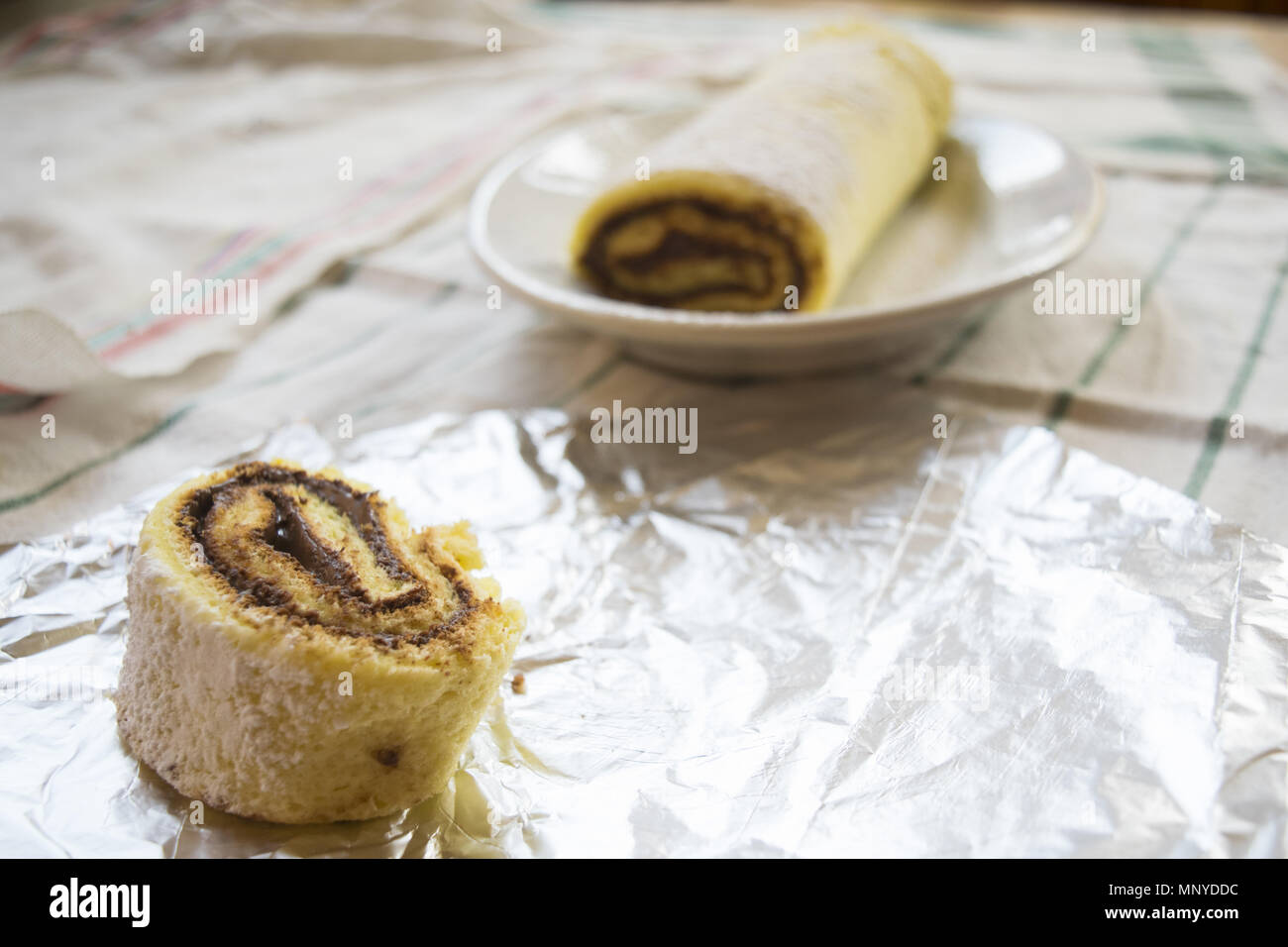 Swiss roll with melted chocolate filling Stock Photo