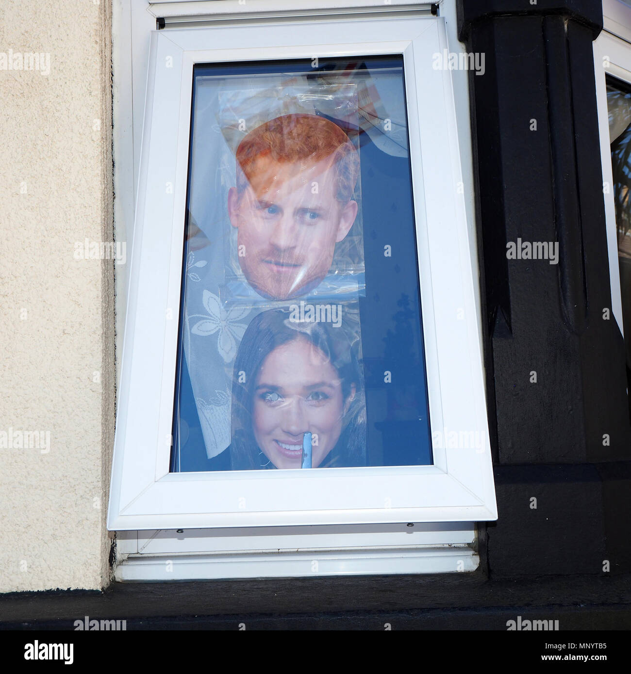 Royal faces masks in window at royal wedding street party celebrating ...