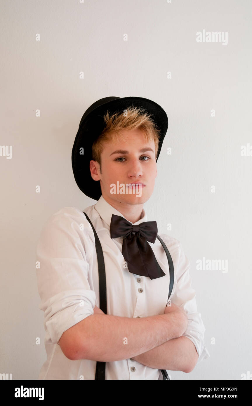 Young man wearing hat, braces and bow tie Stock Photo - Alamy