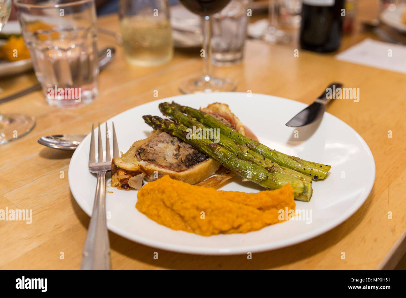 Meatloaf wellington with green asparagus spears and sweet potato garlic mash, main dish, Stock Photo