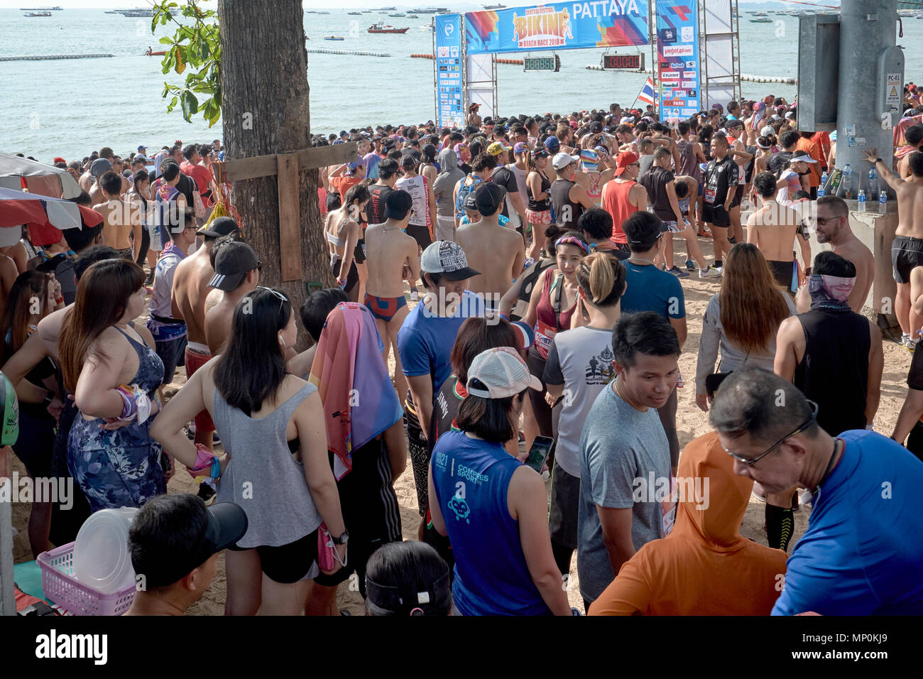 Large crowd lining the beach awaiting the start of a fun run, Pattaya, Thailand, 2018 Stock Photo