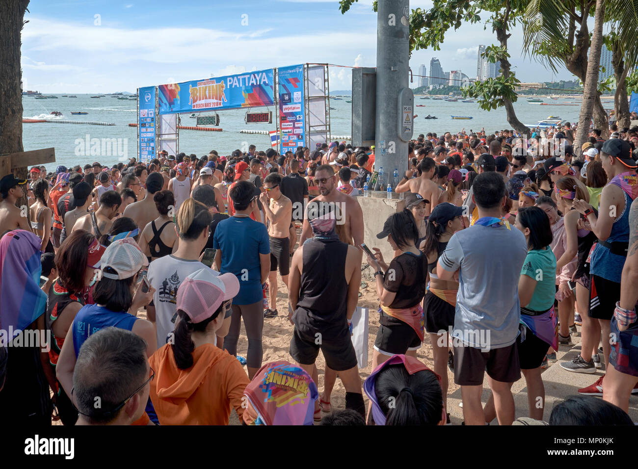 Large crowd lining the beach awaiting the start of a fun run, Pattaya, Thailand, 2018 Stock Photo