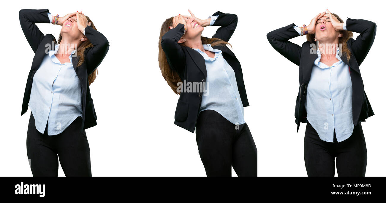 Middle age business woman stressful keeping hands on head, tired and frustrated over white background Stock Photo