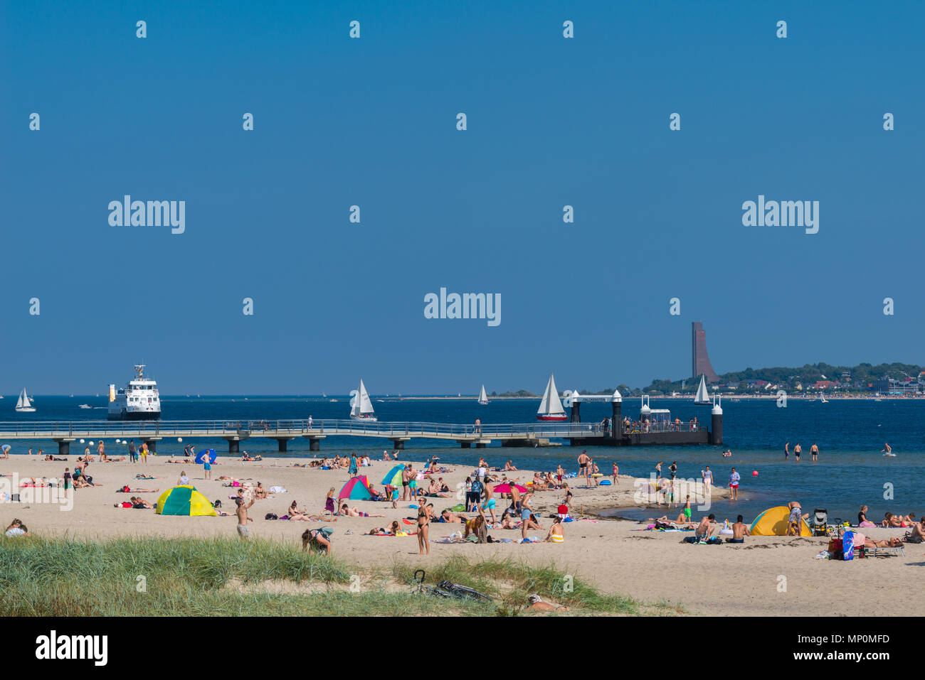 Relaxing at a hot summer day at the beach 'Falkensteiner Strand', the fjord liner coming up to the pier, Kiel Fjord, Kiel, Germany, Stock Photo