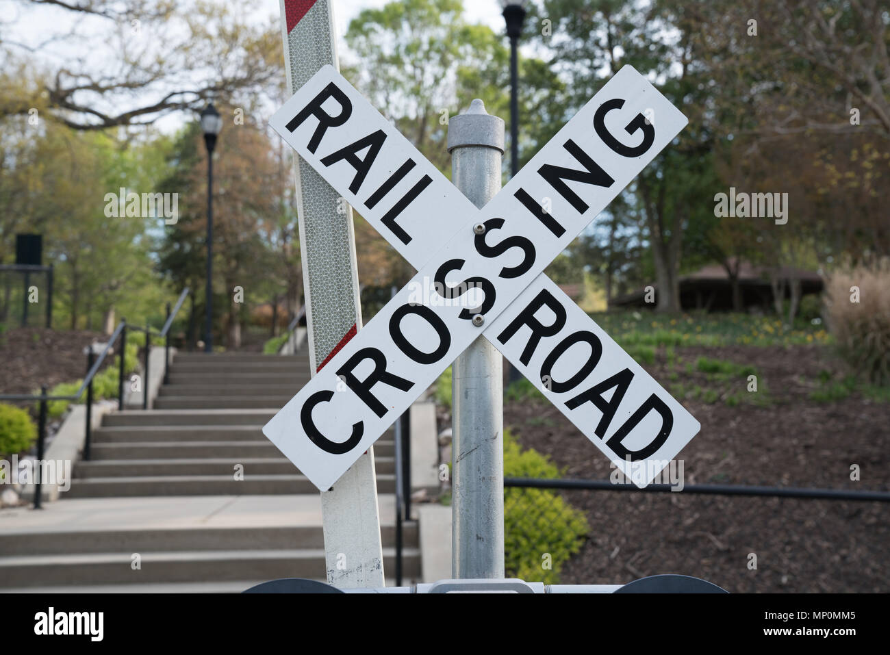 Railroad Crossing Sign along Train Tracks Stock Photo