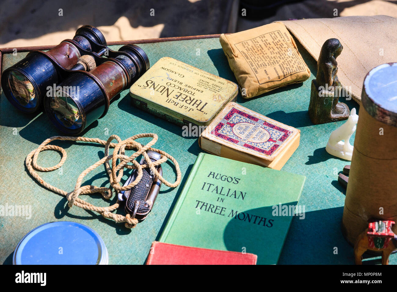 Popular Salute to the 40s at Sandwich. World war two western desert items, deck of cards, three nuns tabacco, binoculars and others on table. Stock Photo