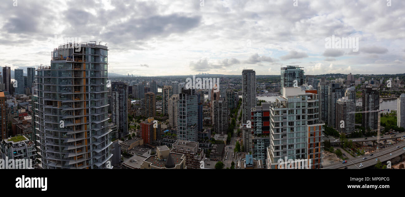 Aerial panoramic view of a beautiful modern cityscape during a cloudy ...