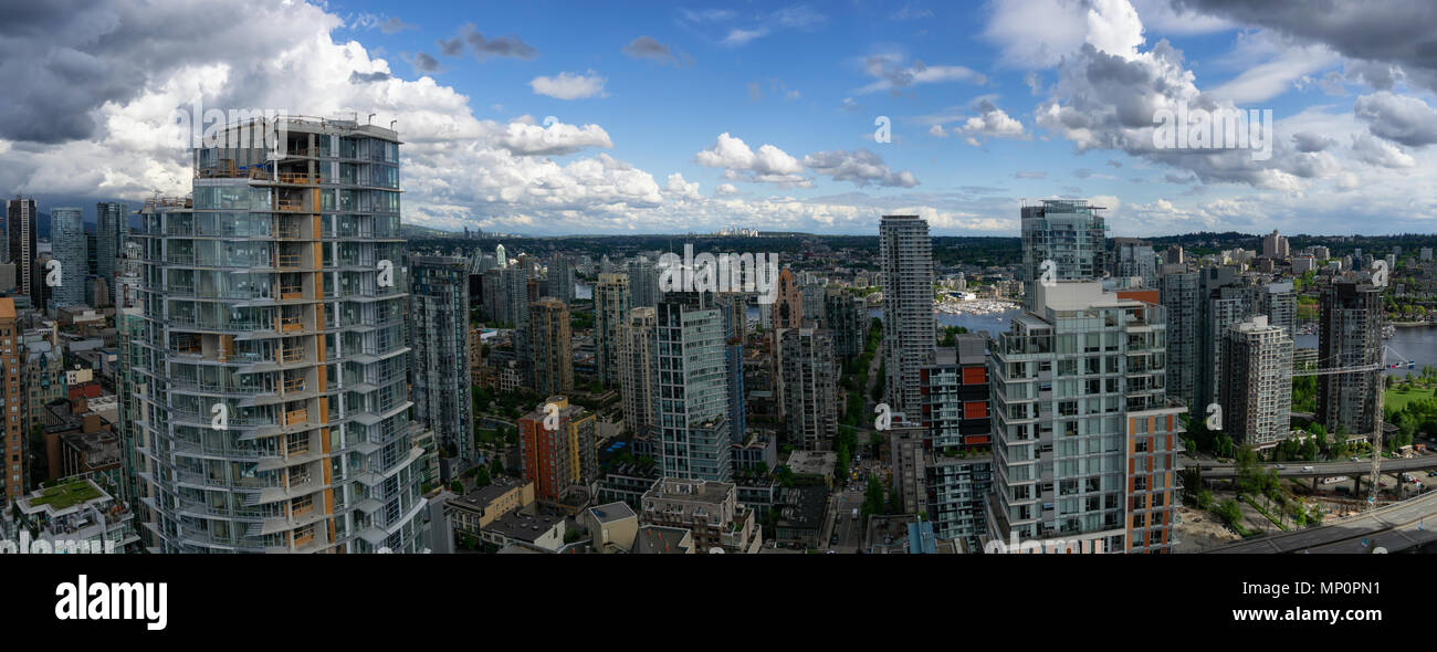 Aerial panoramic view of a beautiful modern cityscape during a cloudy ...