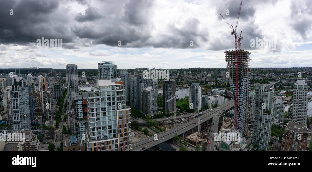 Aerial panoramic view of a beautiful modern cityscape during a cloudy ...