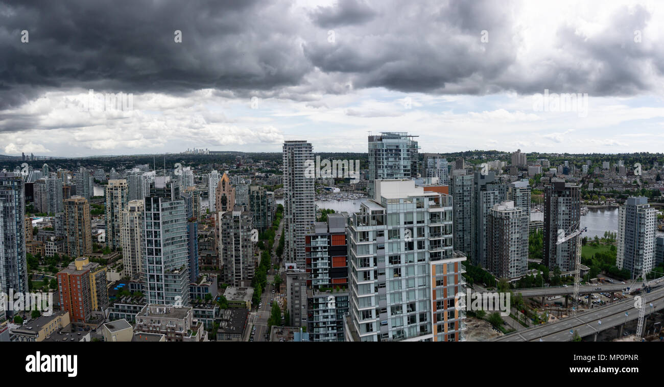 Aerial panoramic view of a beautiful modern cityscape during a cloudy ...