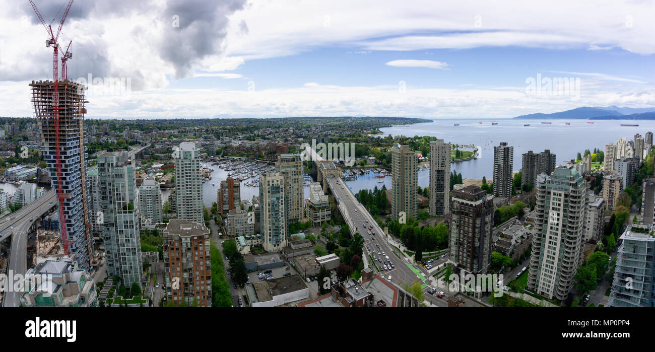 Aerial panoramic view of a beautiful modern cityscape during a cloudy ...