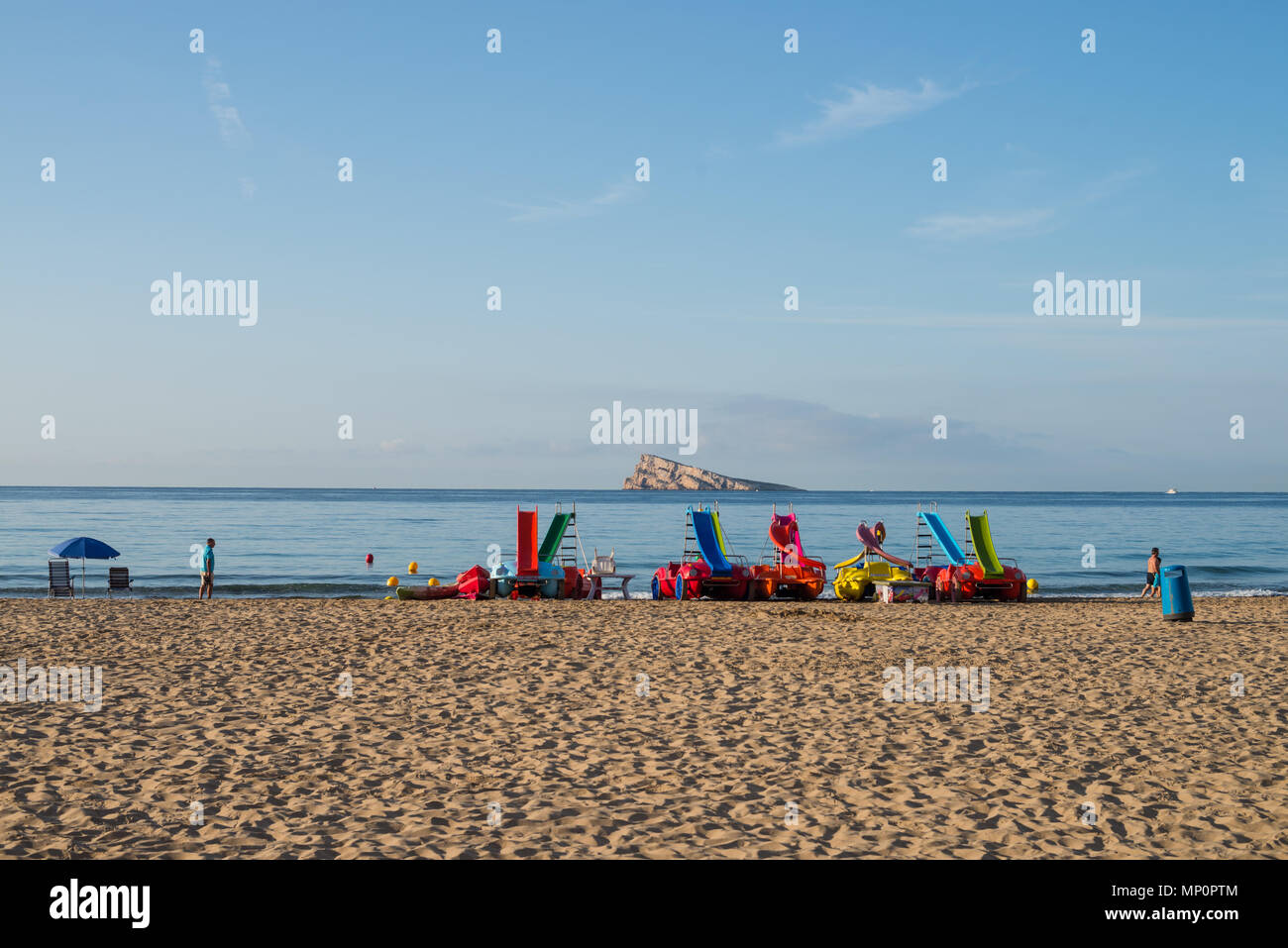 Pedakl boats on Benidorm resort beach with its landmark island in the