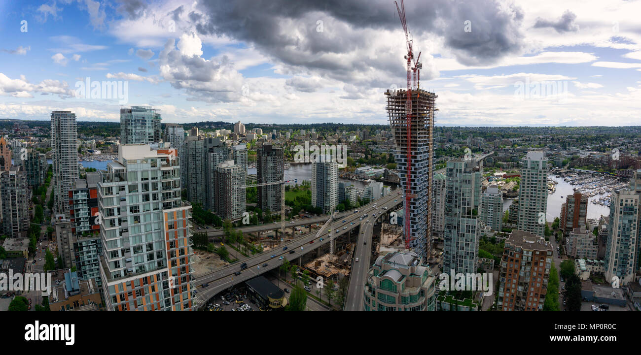 Aerial panoramic view of a beautiful modern cityscape during a cloudy ...