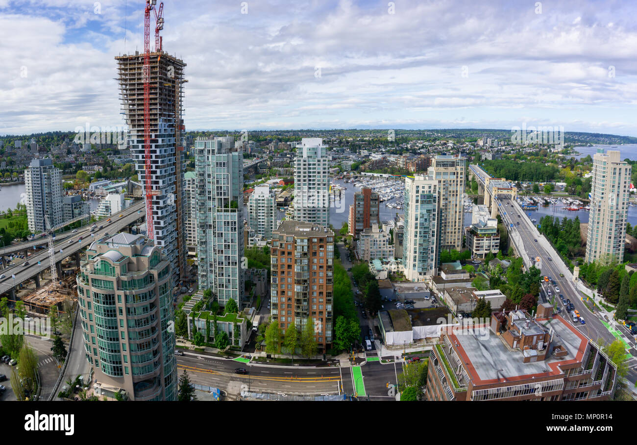 Aerial panoramic view of a beautiful modern cityscape during a cloudy ...