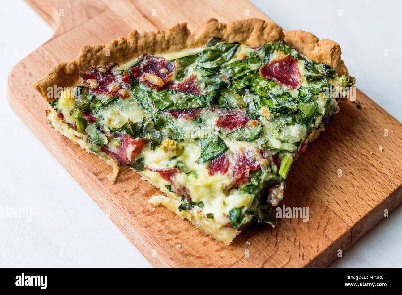 Quiche with Spinach, Chard, Pastrami and Cheese. Traditional Food Stock
