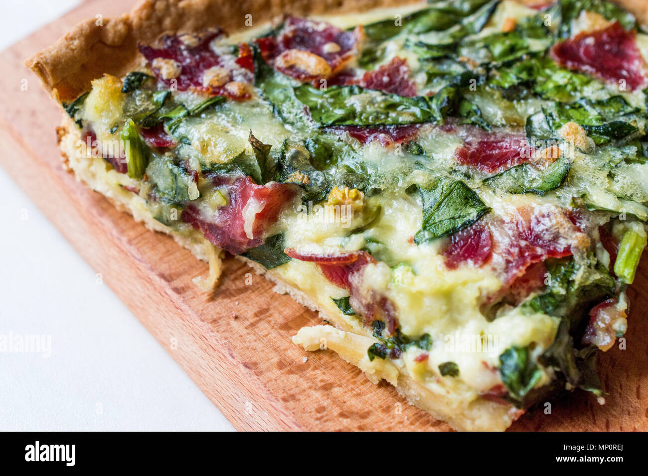 Quiche with Spinach, Chard, Pastrami and Cheese. Traditional Food Stock