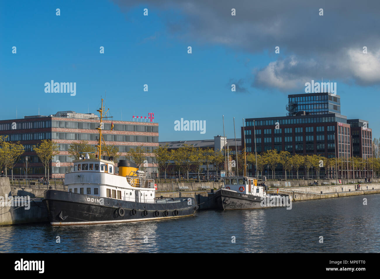 Office buildings and vitage shipstwo tugboats,  at the Hörn, end of Kiel Fjord, Kiel, Schleswig-Holstein, Germany Stock Photo