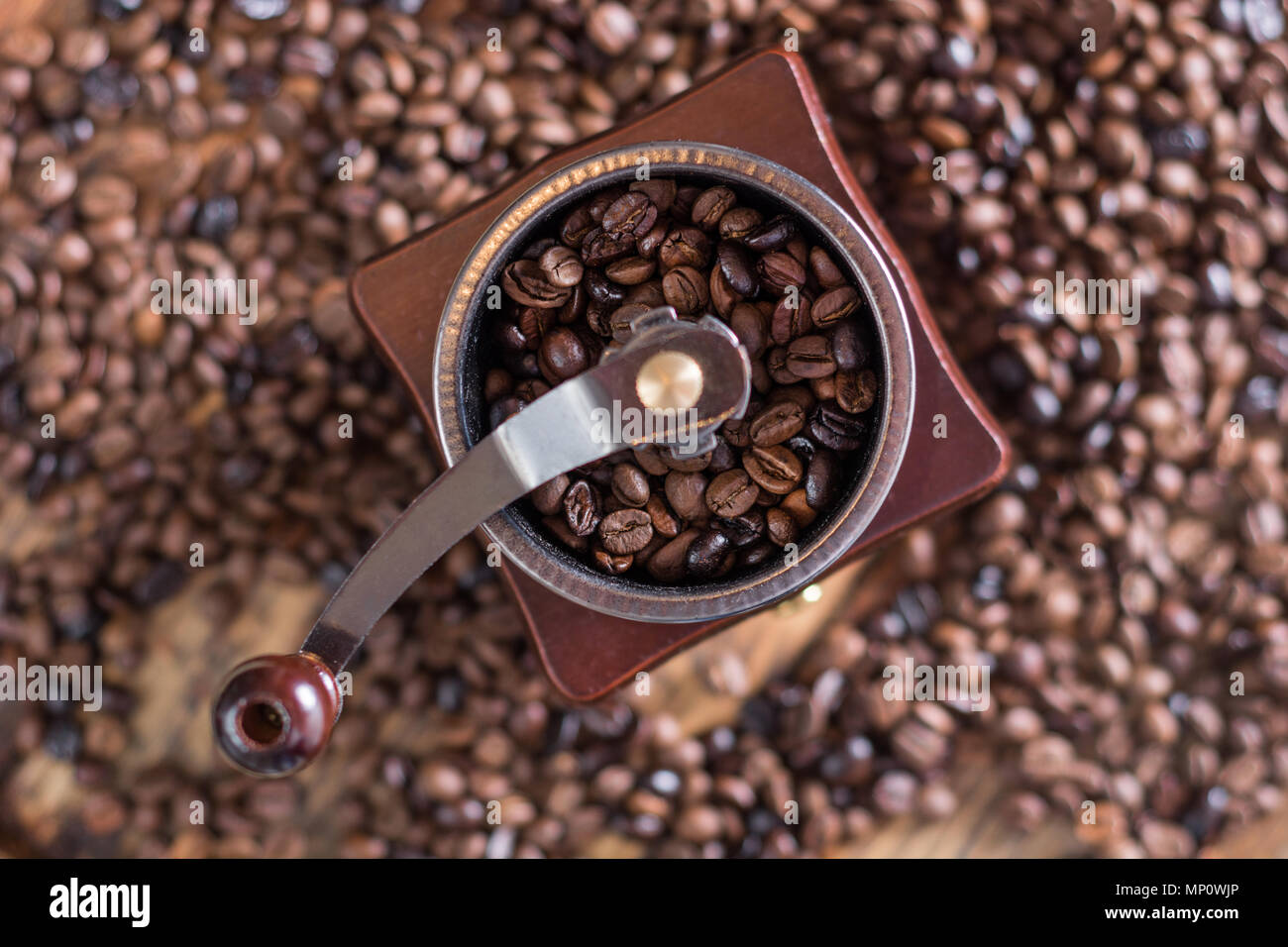 https://c8.alamy.com/comp/MP0WJP/coffee-grinder-and-roasted-coffee-beans-in-background-top-view-selective-focus-MP0WJP.jpg