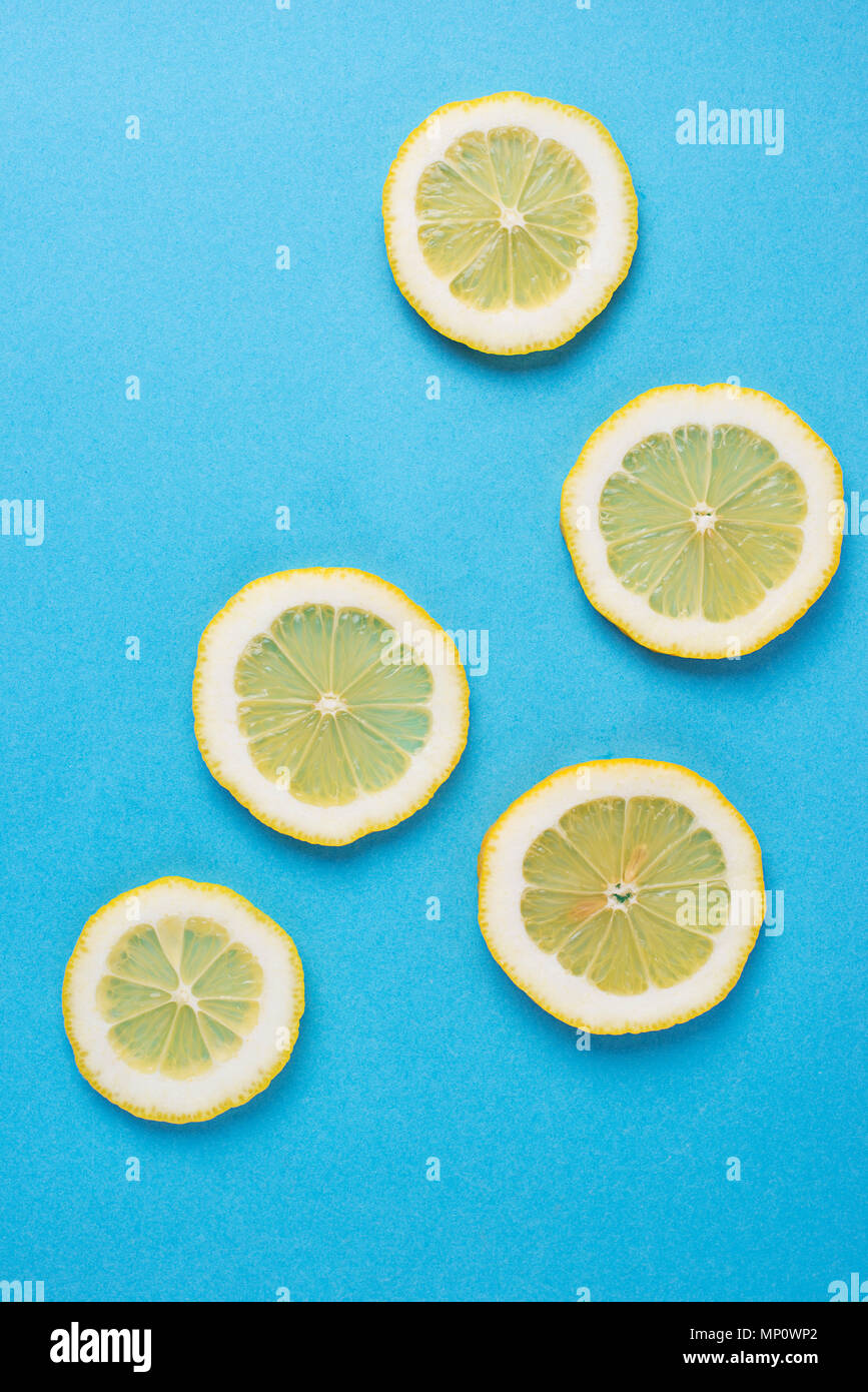 Sliced lemon on blue background Stock Photo