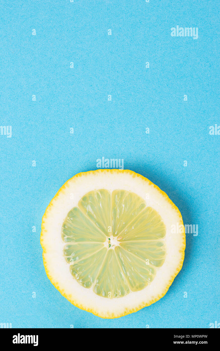 Sliced lemon on blue background Stock Photo