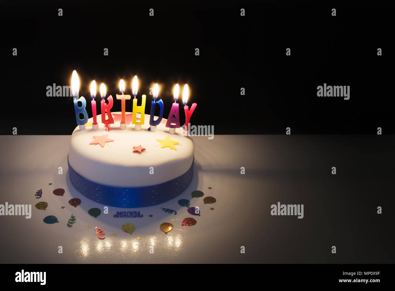 Birthday cake with lighted candles Stock Photo - Alamy